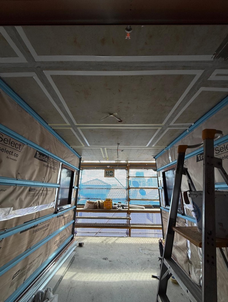 Commercial fit-out interior with a prepared concrete floor ready for the next trade.